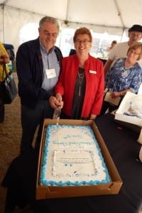 Gibbons Deputy Mayor Louise Bauder helps Fort Air Partnership Chair Keith Purves cut the cake marking the grand opening June 16 of the new Gibbons Air Monitoring Station.