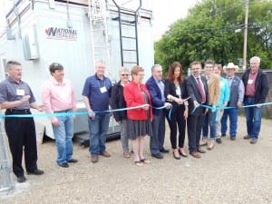 While Fort Air Partnership Board members and other officials look on, Chair Keith Purves and Executive Director Nadine Blaney cut the ribbon officially opening the new Gibbons Air Monitoring Station on June 16. They are assisted by Gibbons Deputy Mayor Louise Bauder and Colin Piquette, MLA, Athabasca-Sturgeon-Redwater.