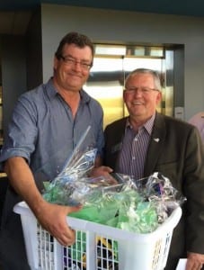 AIHA Chair Ed Gibbons (right) thanks Neil Shelly for his years of service as Executive Director of AIHA with a basket of commonly used petrochemical-derived products.
