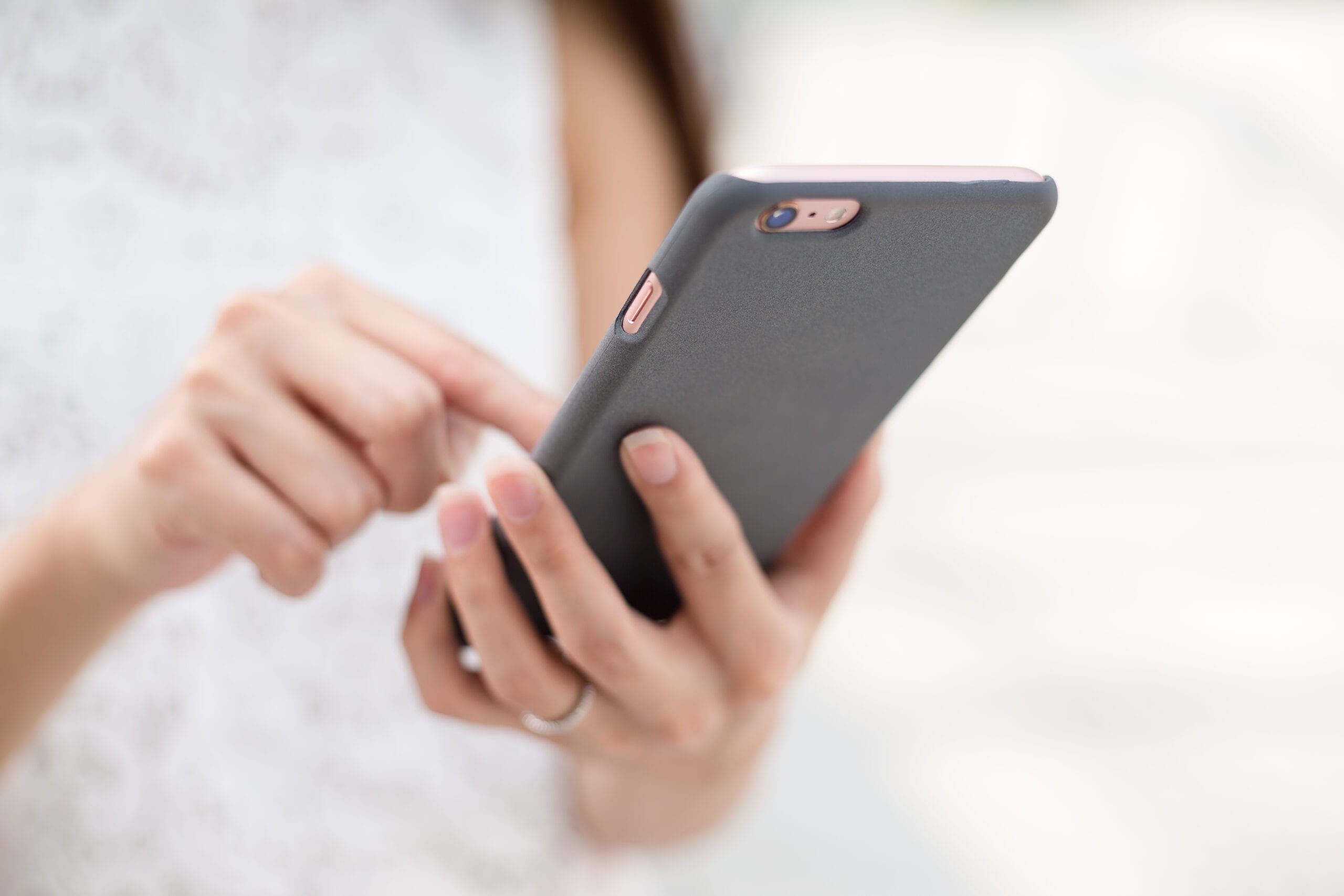 Woman sending message on cellphone